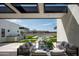 Outdoor patio with seating, a dining area, a built-in grill, and a view of the pool and yard at 10220 N 66Th St, Paradise Valley, AZ 85253