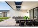 Covered outdoor patio with modern seating and dining areas at 10220 N 66Th St, Paradise Valley, AZ 85253