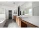 A bright bathroom with a vanity sink, tub, and shower at 12045 W Peak View Rd, Peoria, AZ 85383