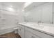 Bright bathroom featuring a double vanity, large mirror, and tile flooring at 1292 S 185Th Dr, Goodyear, AZ 85338