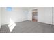 A spacious bedroom with neutral carpet and ample natural light, adjacent to the bathroom at 1292 S 185Th Dr, Goodyear, AZ 85338
