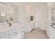 Modern bathroom features dual sinks, sleek white cabinetry, and stylish tile work at 13138 N 173Rd Ln, Surprise, AZ 85388