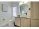 Stylish bathroom with round mirror, vessel sink, and wood grain vanity at 14132 W Bent Tree S Cir, Litchfield Park, AZ 85340