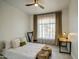 Bedroom with large window, neutral curtains, harp, desk, and white bedding at 14132 W Bent Tree S Cir, Litchfield Park, AZ 85340