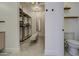 Spacious walk-in closet with custom shelving, bench, and full-length mirror at 14132 W Bent Tree S Cir, Litchfield Park, AZ 85340