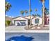 Single-story home with desert landscaping, shade trees, and a two-car garage at 14132 W Bent Tree S Cir, Litchfield Park, AZ 85340