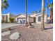 Inviting single-story home featuring xeriscape landscaping and mature trees in the front yard at 14132 W Bent Tree S Cir, Litchfield Park, AZ 85340