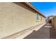 Home exterior featuring an alley with pavers and a stucco wall at 16336 N 168Th Ave, Surprise, AZ 85388