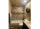 Well-lit bathroom with a combination shower and tub, decorative mirror and vanity at 16336 N 168Th Ave, Surprise, AZ 85388