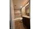 Cozy bathroom featuring a bath and shower combination with tiled walls and a dark wood vanity at 16336 N 168Th Ave, Surprise, AZ 85388