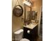 Charming bathroom featuring a decorative mirror, vanity with granite countertop and a toilet at 16336 N 168Th Ave, Surprise, AZ 85388