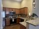 Modern kitchen featuring stainless steel appliances, granite countertops, and contemporary pendant lighting at 16336 N 168Th Ave, Surprise, AZ 85388