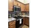 Bright kitchen showcasing stainless steel appliances, granite countertops, and warm wooden cabinets at 16336 N 168Th Ave, Surprise, AZ 85388