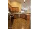 This is a kitchen with wooden cabinetry, granite countertops, and stainless steel appliances at 16336 N 168Th Ave, Surprise, AZ 85388