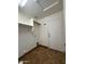 Laundry room featuring tile flooring, shelving, and a door to the outside at 16336 N 168Th Ave, Surprise, AZ 85388