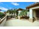 Landscaped side exterior featuring palm trees and mature vegetation at 16436 W Arroyo Vista Ln, Surprise, AZ 85374