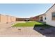 Spacious backyard featuring a putting green, lush lawn, and desert landscaping for outdoor enjoyment at 17816 W Oregon Ave, Litchfield Park, AZ 85340