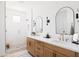 Elegant primary bathroom with a tiled glass shower and double sink vanity with neutral countertop and modern fixtures at 17816 W Oregon Ave, Litchfield Park, AZ 85340