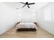Primary bedroom featuring hardwood floors, recessed lighting, and bright windows and plantation shutters at 17816 W Oregon Ave, Litchfield Park, AZ 85340