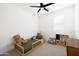 Well-lit room with a ceiling fan, light carpet, and play area at 17816 W Oregon Ave, Litchfield Park, AZ 85340
