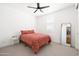 Neutral bedroom with a ceiling fan, light carpet, and a comfy bed at 17816 W Oregon Ave, Litchfield Park, AZ 85340