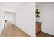 Bright hallway featuring light wood floors, white walls, and stylish decor at 17816 W Oregon Ave, Litchfield Park, AZ 85340