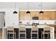 Bright kitchen featuring a large island with seating, pendant lights, white countertops, and ample cabinet space at 17816 W Oregon Ave, Litchfield Park, AZ 85340