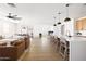 Bright open-concept living space features a kitchen island, hardwood floors, and modern furnishings at 17816 W Oregon Ave, Litchfield Park, AZ 85340