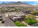 Aerial view of a Southwestern house with well-kept lawn and desert mountain views at 1815 W Maddock Rd, Phoenix, AZ 85086