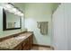 Bathroom featuring a vanity with granite countertops, a large mirror, and a shower at 1815 W Maddock Rd, Phoenix, AZ 85086