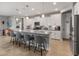 Modern kitchen with white cabinets, gray countertops, and a large kitchen island at 18768 W Clinton St, Surprise, AZ 85388