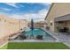 Inviting backyard oasis with a sparkling pool, lounge chairs, and artificial grass at 18768 W Clinton St, Surprise, AZ 85388