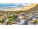 Wide aerial shot of a neighborhood displaying a mix of homes and manicured yards, with mountain views at 1955 E Greenway Rd, Phoenix, AZ 85022