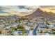 Expansive aerial view of a residential neighborhood, showing rooftops, roads, and desert landscape at 1955 E Greenway Rd, Phoenix, AZ 85022