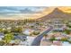 Aerial view of a residential neighborhood with mountain backdrop; many homes have swimming pools at 1955 E Greenway Rd, Phoenix, AZ 85022