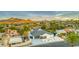 Aerial view of a modern home amidst a residential area, featuring mountain views in the background at 1955 E Greenway Rd, Phoenix, AZ 85022