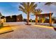 Striking backyard featuring a modern gazebo, desert landscaping, and accent lighting at 1955 E Greenway Rd, Phoenix, AZ 85022