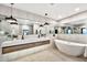 Well-lit bathroom showcases dual sink vanity, soaking tub, and modern design at 1955 E Greenway Rd, Phoenix, AZ 85022