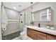 Modern bathroom with a glass shower, toilet, and wood vanity with white countertop at 1955 E Greenway Rd, Phoenix, AZ 85022