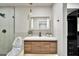 Modern bathroom featuring a wood vanity with a white countertop, and a large mirror at 1955 E Greenway Rd, Phoenix, AZ 85022