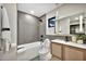 Modern bathroom featuring sleek fixtures, neutral tones, and a vanity with woven door fronts at 1955 E Greenway Rd, Phoenix, AZ 85022