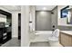 Modern bathroom with gray tile shower, toilet, and vanity featuring sleek and modern hardware at 1955 E Greenway Rd, Phoenix, AZ 85022