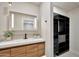 Bathroom featuring a wood vanity with a white countertop, and a custom closet at 1955 E Greenway Rd, Phoenix, AZ 85022