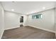 Open bedroom with hardwood floors, neutral walls, and a view into an attached bathroom at 1955 E Greenway Rd, Phoenix, AZ 85022