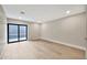 Bright room with wood floors and a sliding glass door with a view to an enclosed patio at 1955 E Greenway Rd, Phoenix, AZ 85022