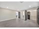 Spacious bedroom featuring gray tile flooring, neutral walls, walk-in closet, and ensuite bathroom at 1955 E Greenway Rd, Phoenix, AZ 85022