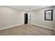 Bedroom with hardwood floors, neutral walls, and a dark door leading to another room at 1955 E Greenway Rd, Phoenix, AZ 85022