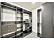 Walk-in closet featuring custom built-in shelving and drawers for optimal organization at 1955 E Greenway Rd, Phoenix, AZ 85022