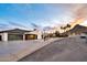 Modern home with desert landscaping, sleek garage door and stylish exterior lighting at 1955 E Greenway Rd, Phoenix, AZ 85022