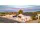 Modern home featuring xeriscaping, a black garage door, and mountain views at 1955 E Greenway Rd, Phoenix, AZ 85022